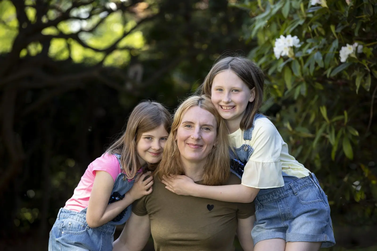 Gina with her two daughters in the garden