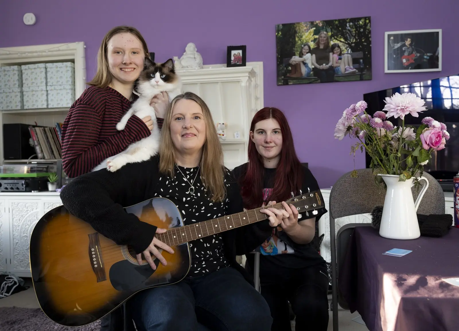 Gina and her daughters at home with their cat