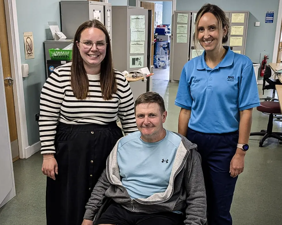 Eve Young, patient Allan Campbell and occupational therapist Jennifer Cloughley together on the ward at the Queen Elizabeth University Hospital